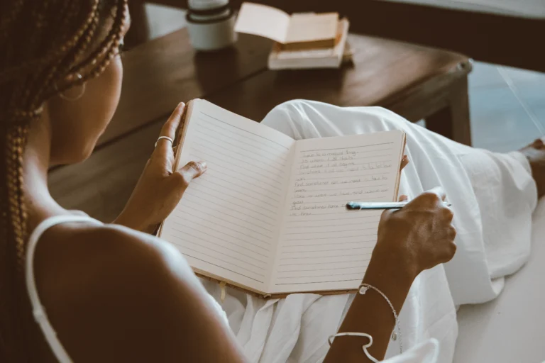 An open journal beside a cup of tea