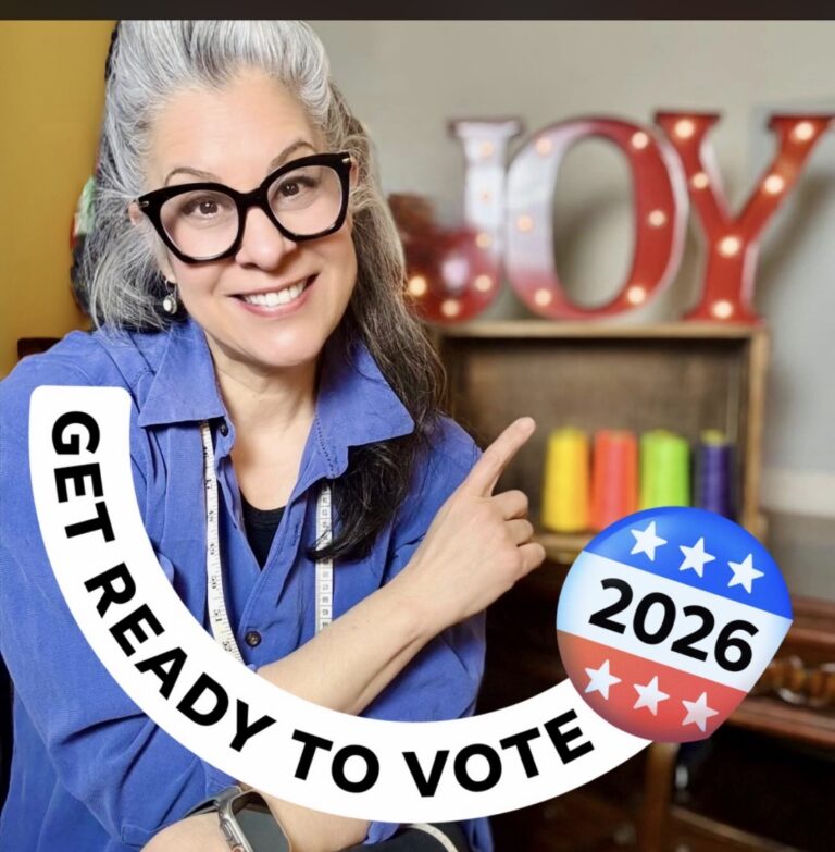 Rev. Kristina Soto pointing to a Get Ready to Vote 2026 badge
